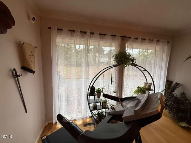 a living room with furniture and a floor to ceiling window