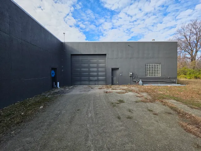 a view of a yard with wooden fence