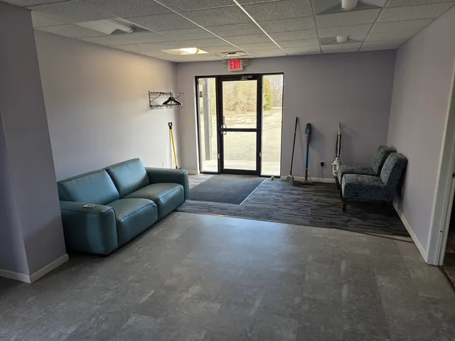 a view of a kitchen with a sink and wooden cabinets