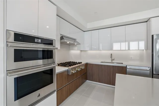 a kitchen with stainless steel appliances refrigerator and microwave