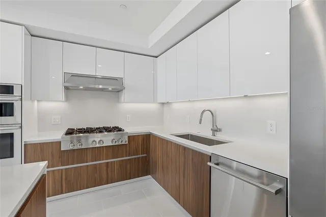 a kitchen with a refrigerator and a stove