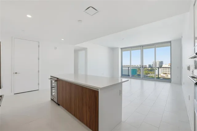 a kitchen with stainless steel appliances white cabinets and a stove top oven
