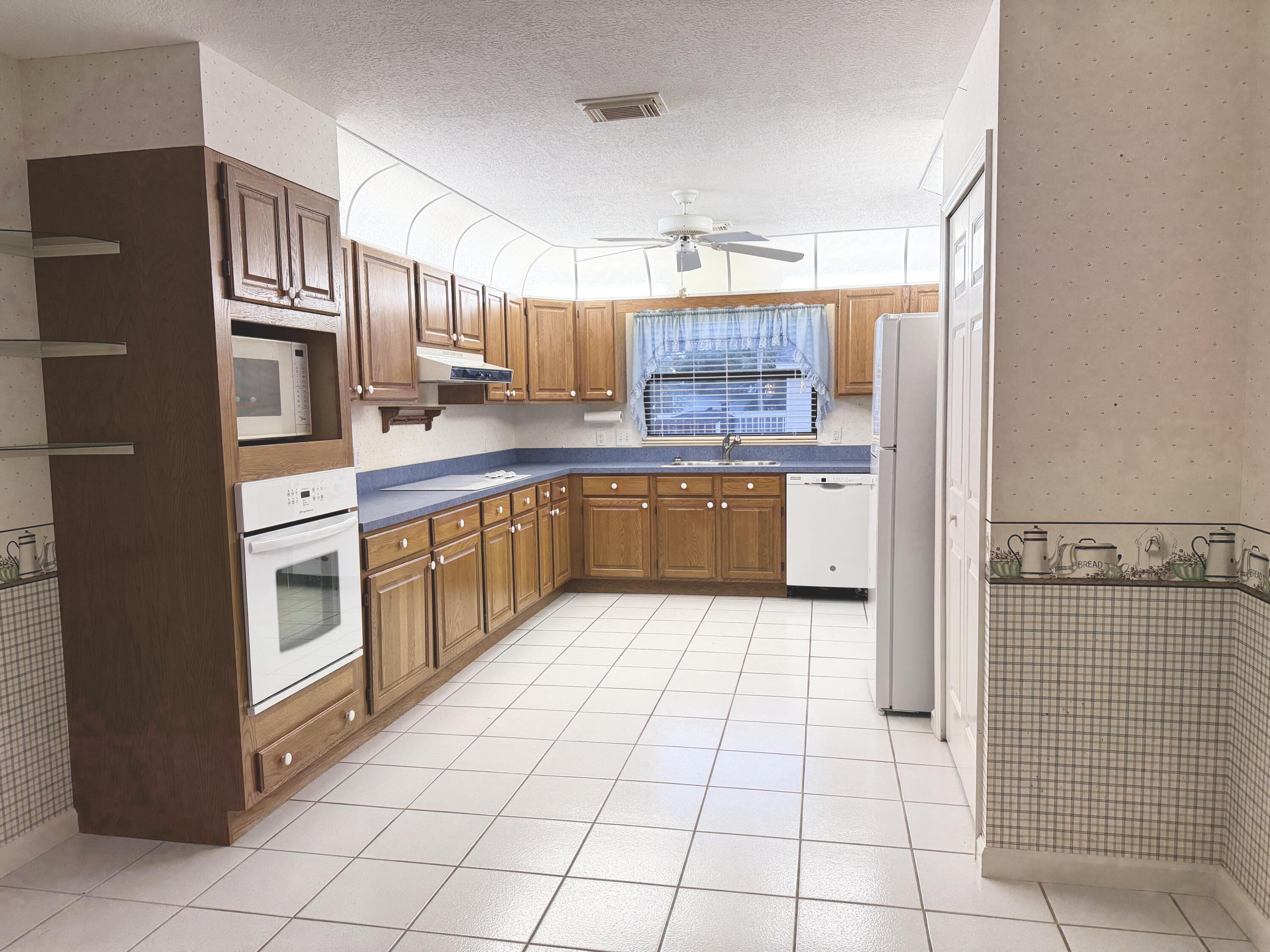 6539 Southeast Held Court Stuart, FL 34997 - Photo 15 of 34 a kitchen with stainless steel appliances a sink and counter space