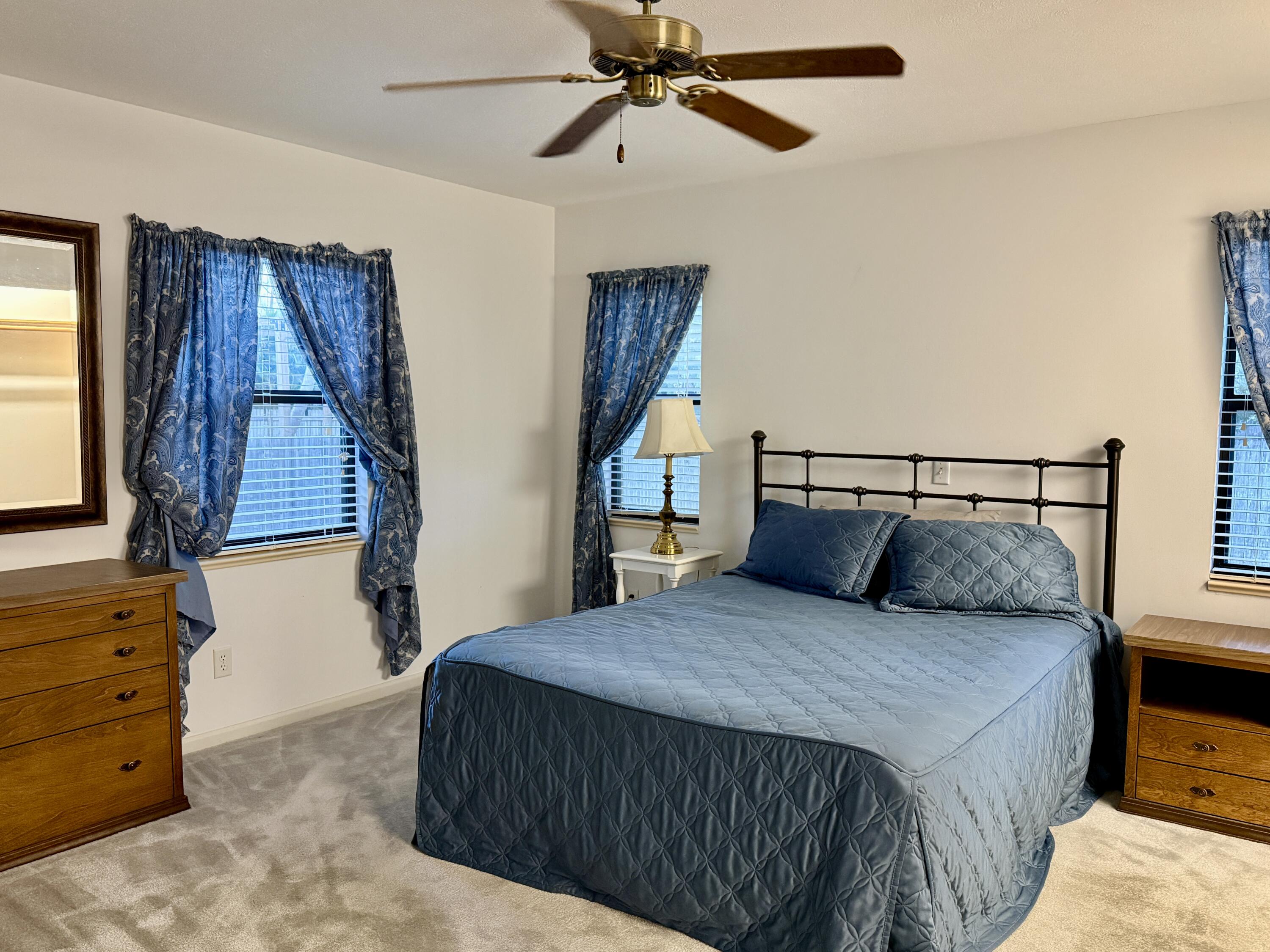 6539 Southeast Held Court Stuart, FL 34997 - Photo 18 of 34 a bedroom with a bed and a window