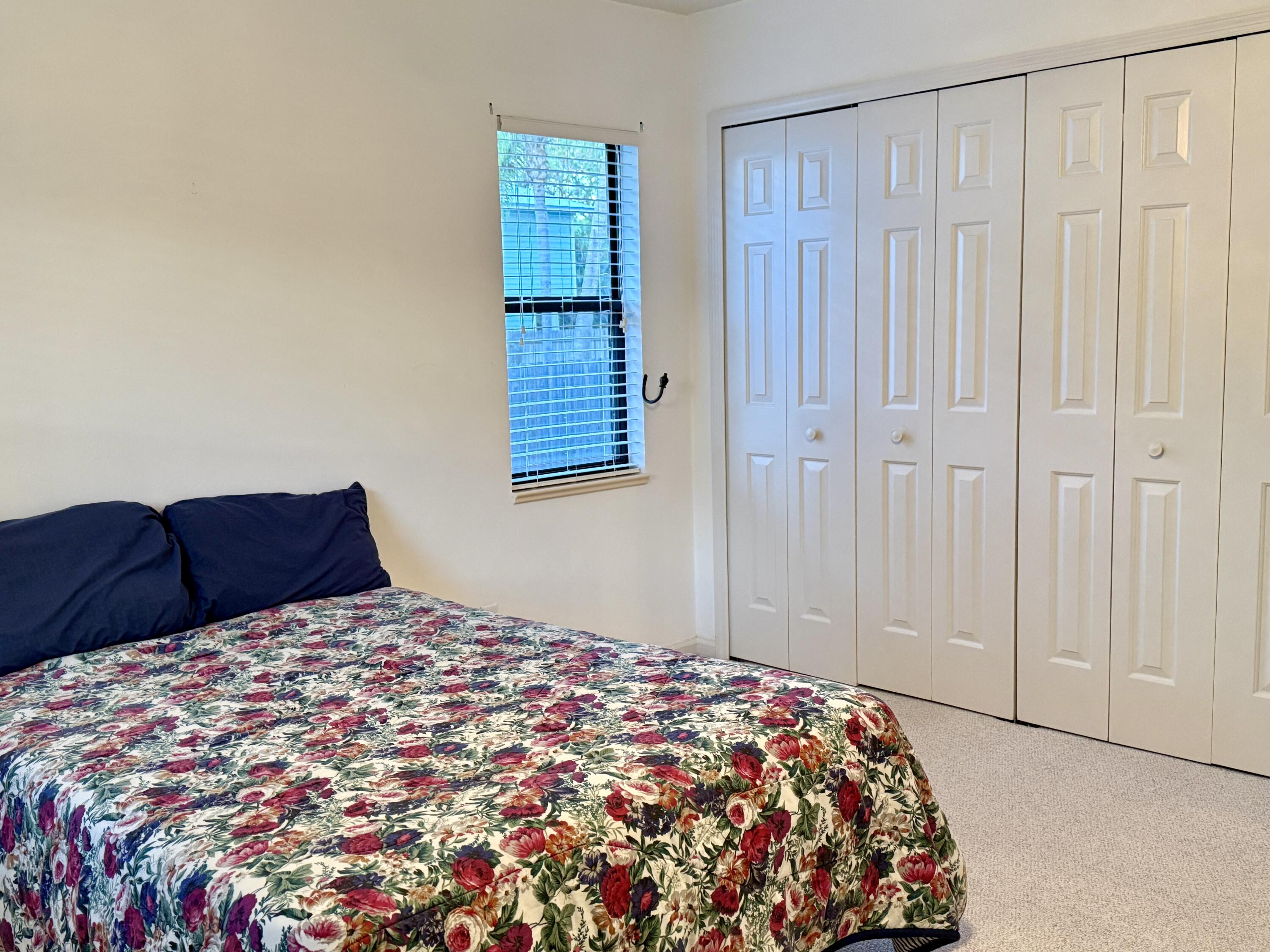 6539 Southeast Held Court Stuart, FL 34997 - Photo 23 of 34 a bedroom with a bed and a window