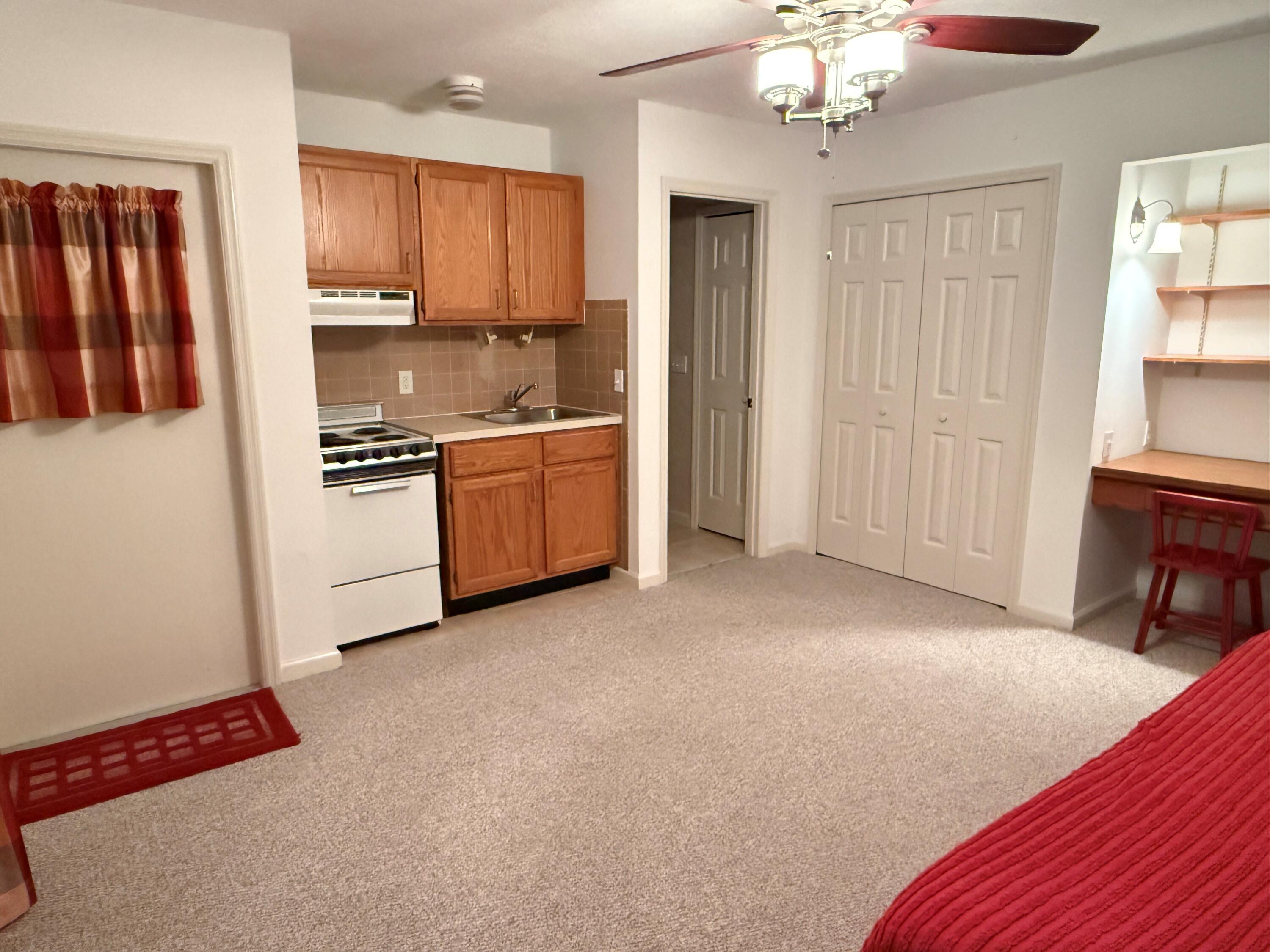 6539 Southeast Held Court Stuart, FL 34997 - Photo 27 of 34 a kitchen with stainless steel appliances granite countertop a refrigerator a stove top oven a sink and dishwasher
