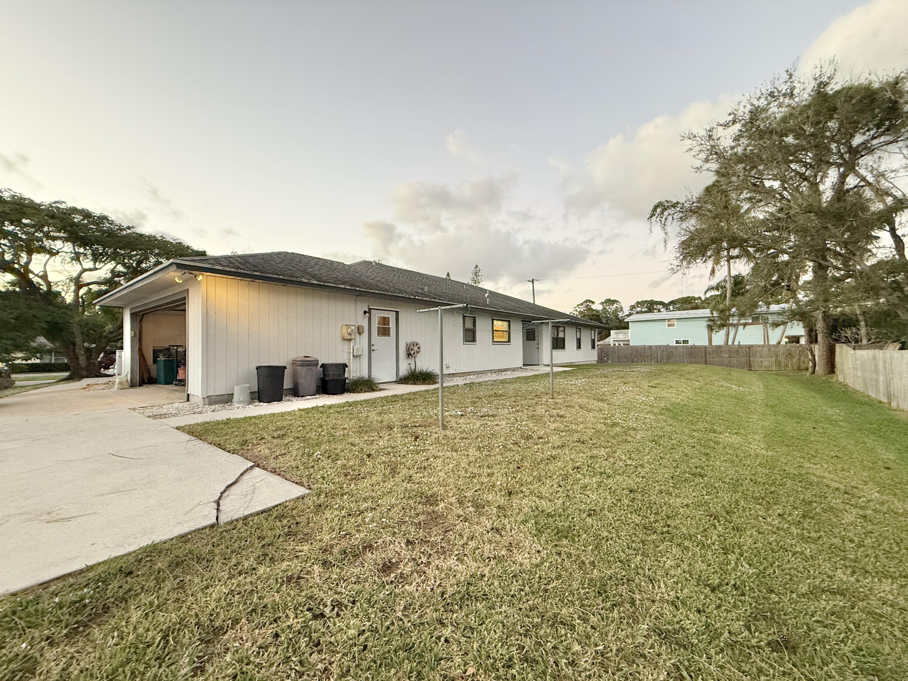 6539 Southeast Held Court Stuart, FL 34997 - Photo 29 of 34 a front view of house with yard and trees around