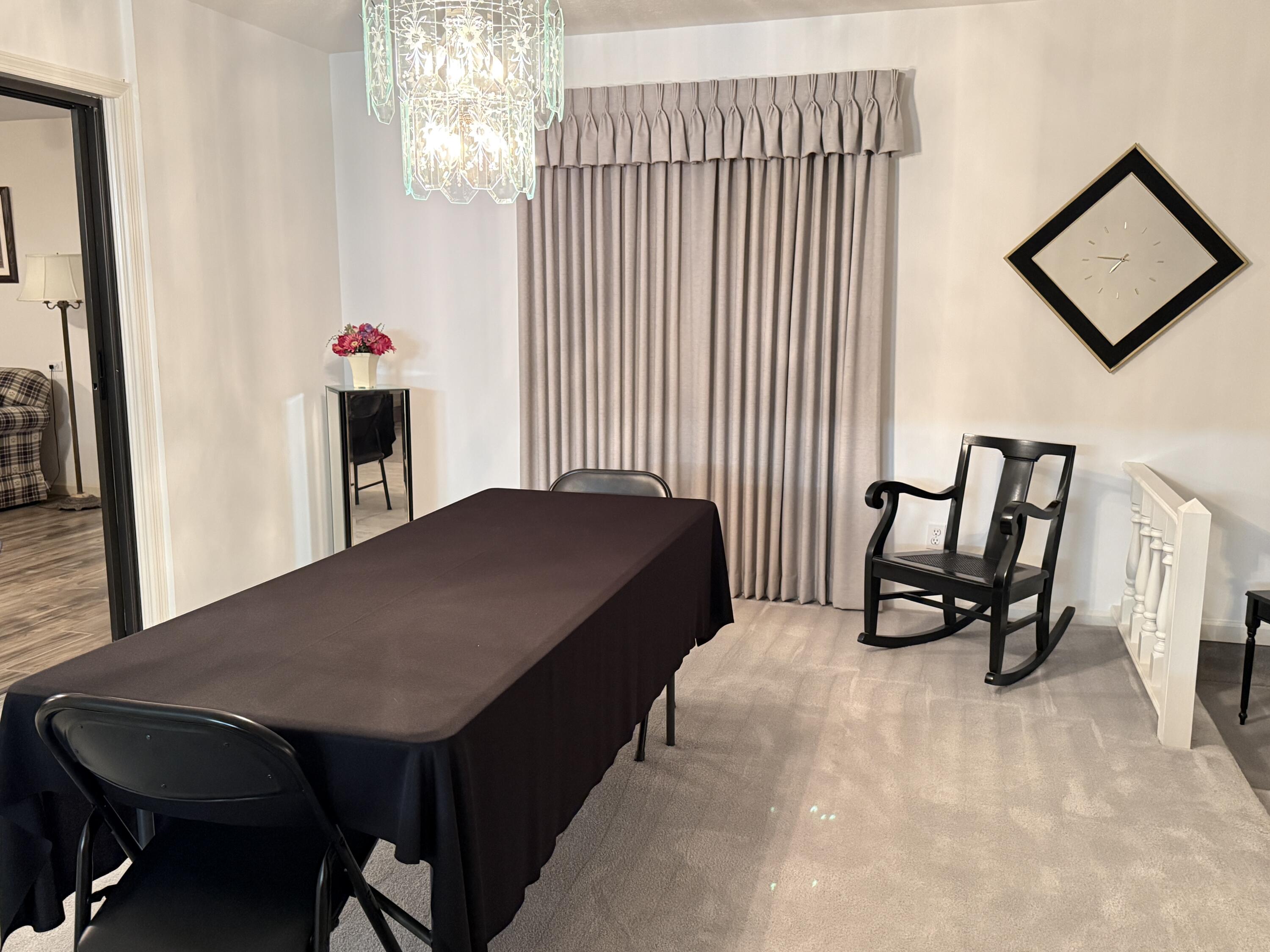 6539 Southeast Held Court Stuart, FL 34997 - Photo 8 of 34 a bedroom with a bed a table and chair