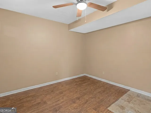 a view of a room with wooden floor