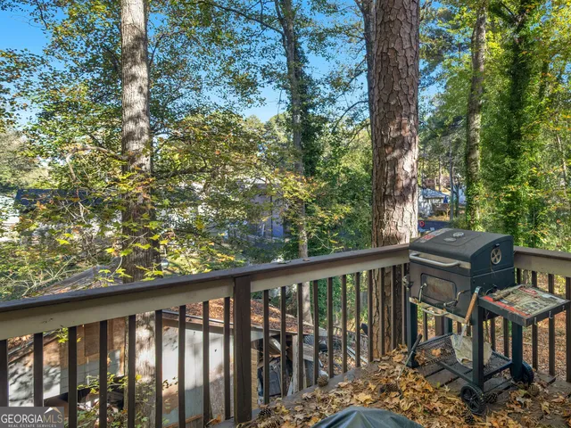 a view of a balcony with wooden floor and fence