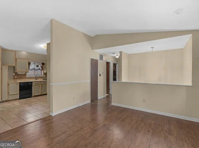 a view of a kitchen with a sink and a refrigerator