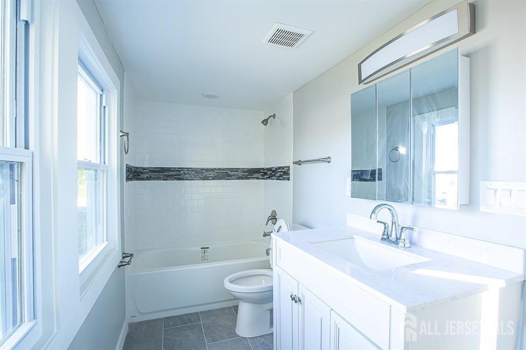 213 Summerhill Road Spotswood, NJ 08884 - Photo 13 of 21 a bathroom with a sink a toilet and shower