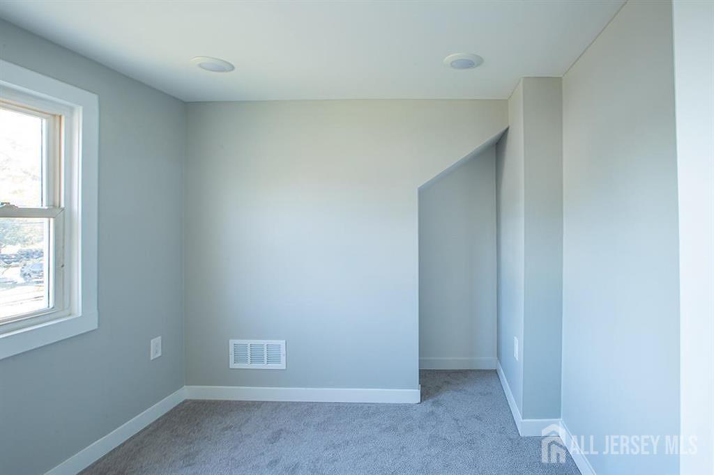 213 Summerhill Road Spotswood, NJ 08884 - Photo 17 of 21 an empty room with a window