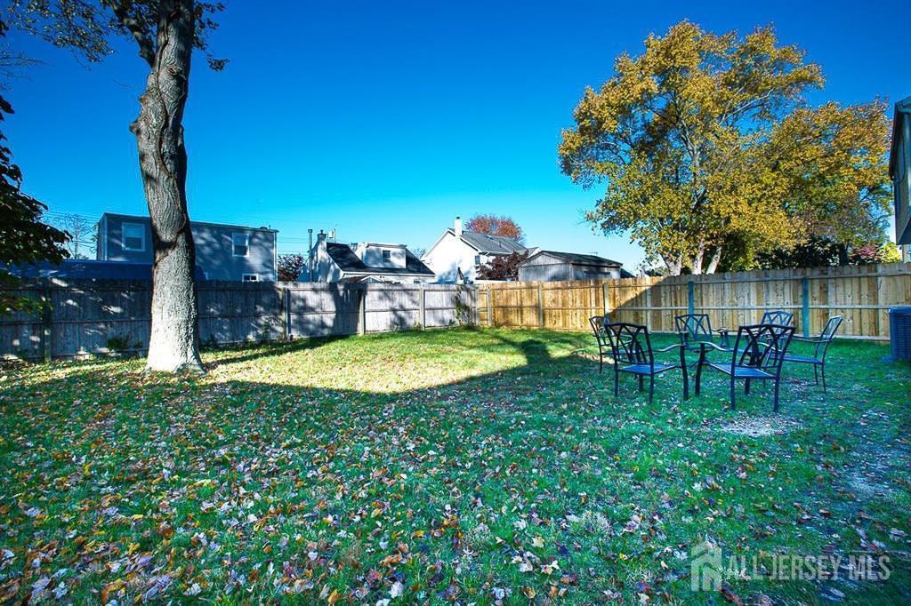 213 Summerhill Road Spotswood, NJ 08884 - Photo 20 of 21 a view of a swimming pool with a table and chairs