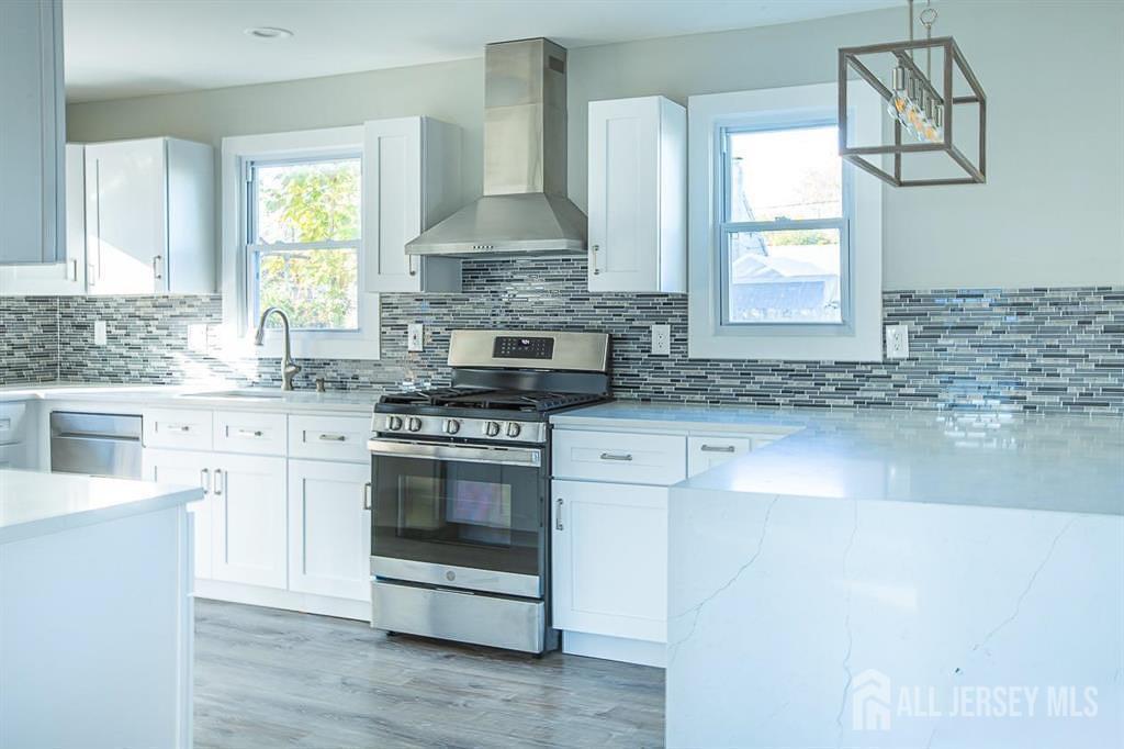 213 Summerhill Road Spotswood, NJ 08884 - Photo 4 of 21 a kitchen with stainless steel appliances granite countertop a sink stove and cabinets