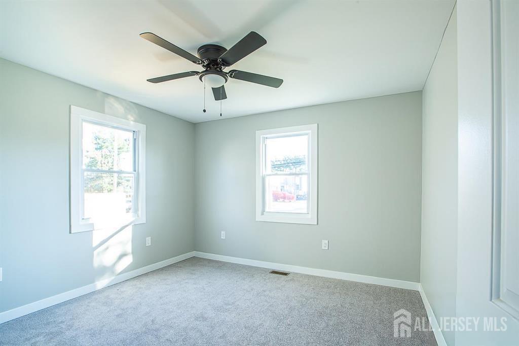 213 Summerhill Road Spotswood, NJ 08884 - Photo 7 of 21 an empty room with windows and fan