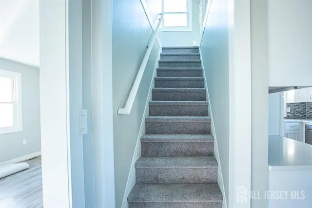 a view of staircase with white walls and windows