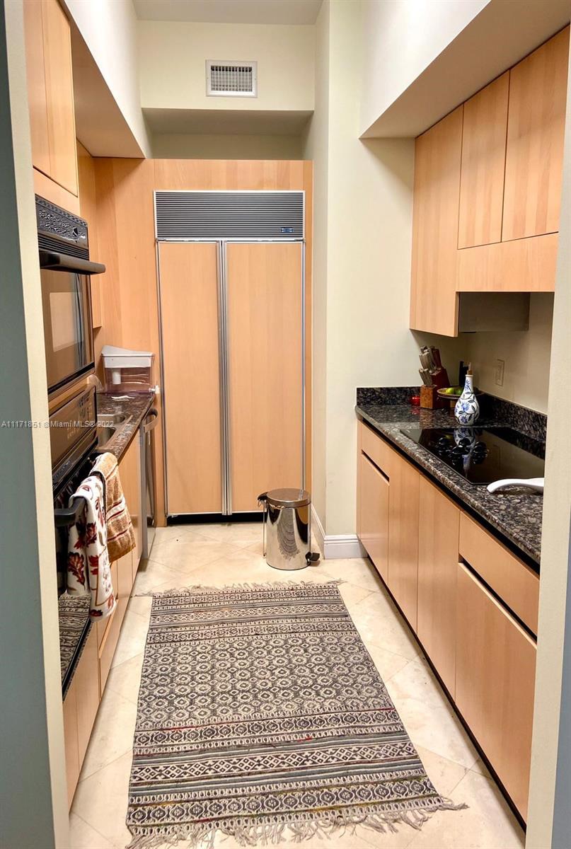 Key Biscayne Key Biscayne, FL 33149 - Photo 6 of 18 a kitchen with stainless steel appliances granite countertop a stove a sink and a microwave