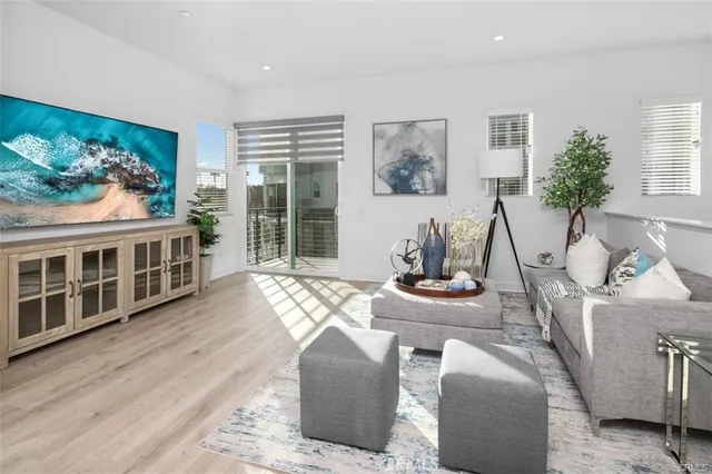 a living room with furniture a piano and a bookshelf