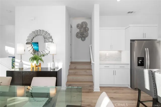 a living room with furniture and a wall painting