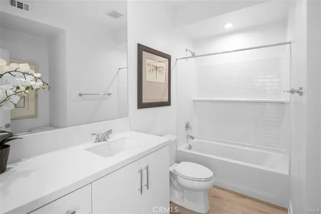 a bedroom with bed and wooden floor