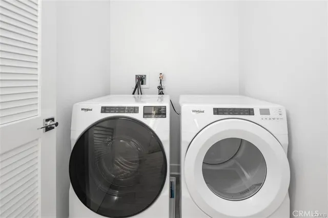 a view of walk in closet with clothes
