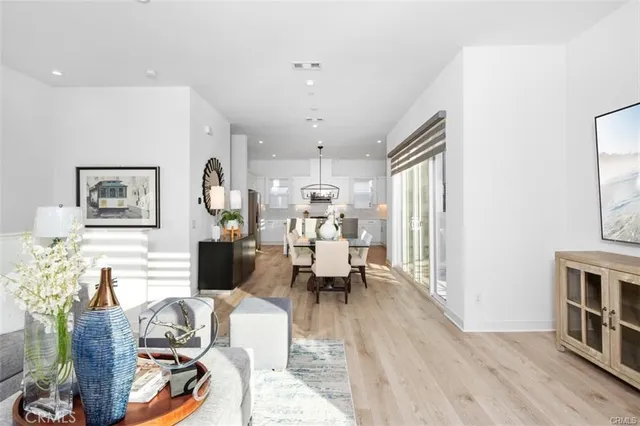 a living room with furniture or dining table and wooden floor