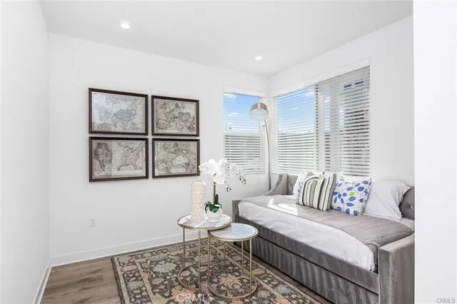 a dining room with furniture a chandelier and wooden floor