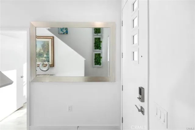 a dining room with furniture a kitchen and chandelier