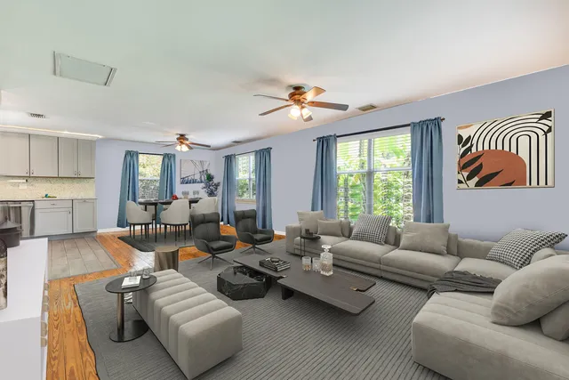 a living room with furniture ceiling fan and a window