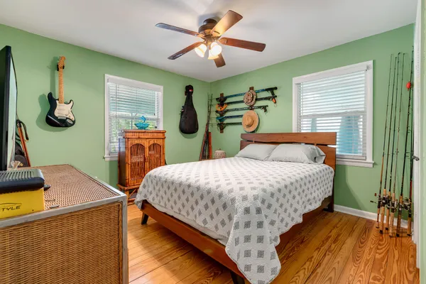 a bedroom with a bed and a chandelier