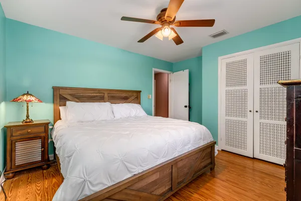 a bedroom with a bed and a chandelier