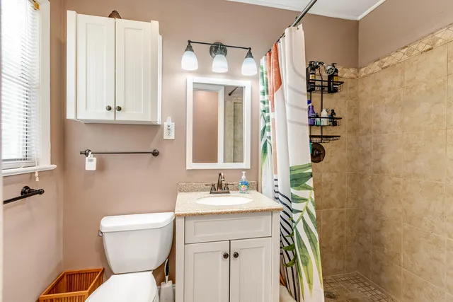 a bathroom with a sink toilet and shower