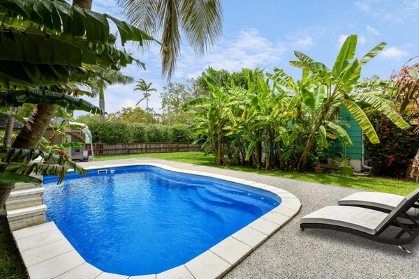 a view of a swimming pool with lounge chair