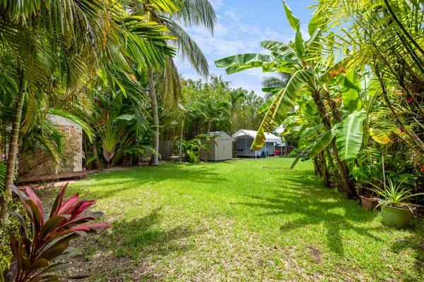 a view of a backyard with a garden and entertaining space