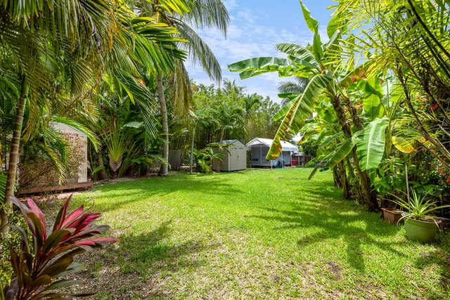 a view of a backyard with a garden and entertaining space