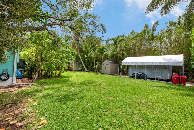 a car parked in front of a house with a garden