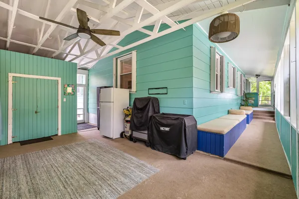 a bedroom with furniture and a wooden floor