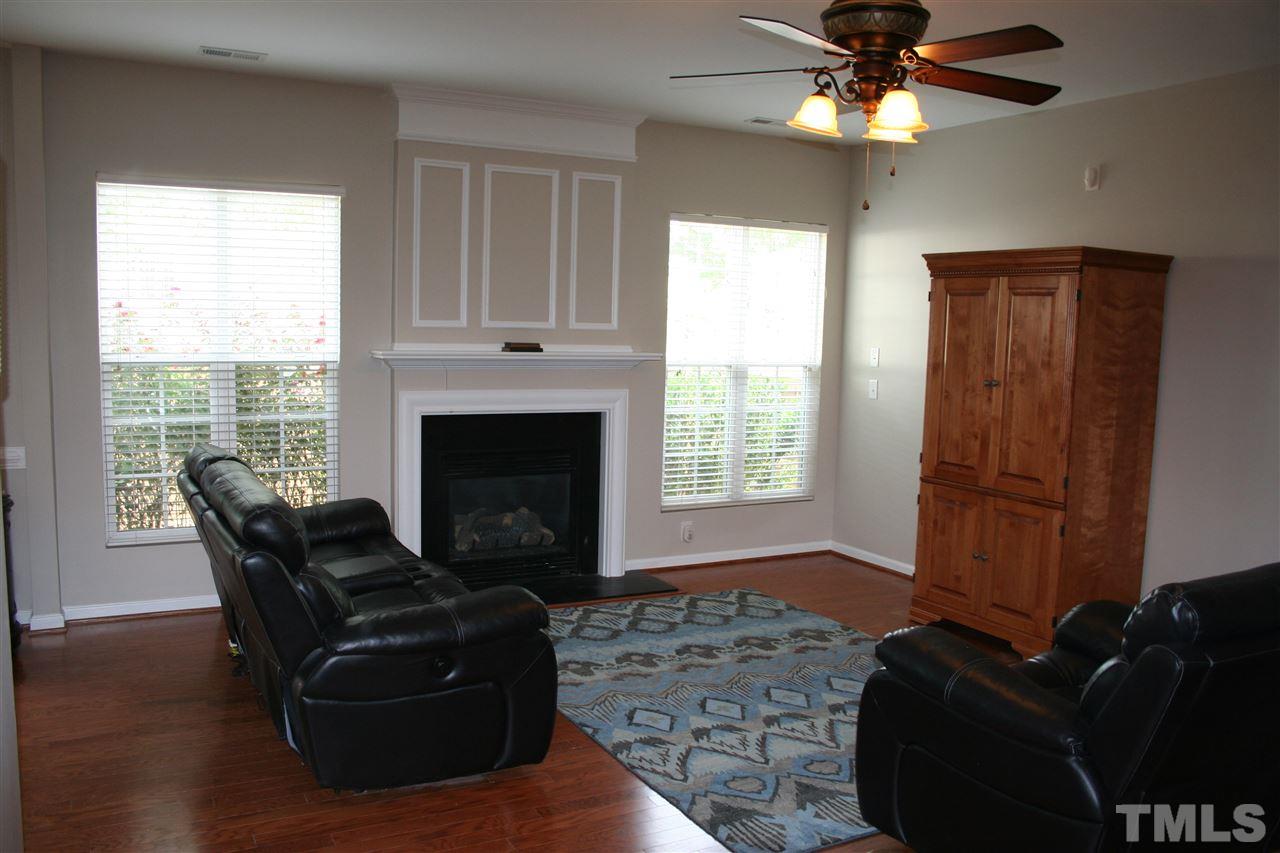 7727 Tanby Court Raleigh, NC 27613 - Photo 3 of 25 a living room with furniture and a fireplace