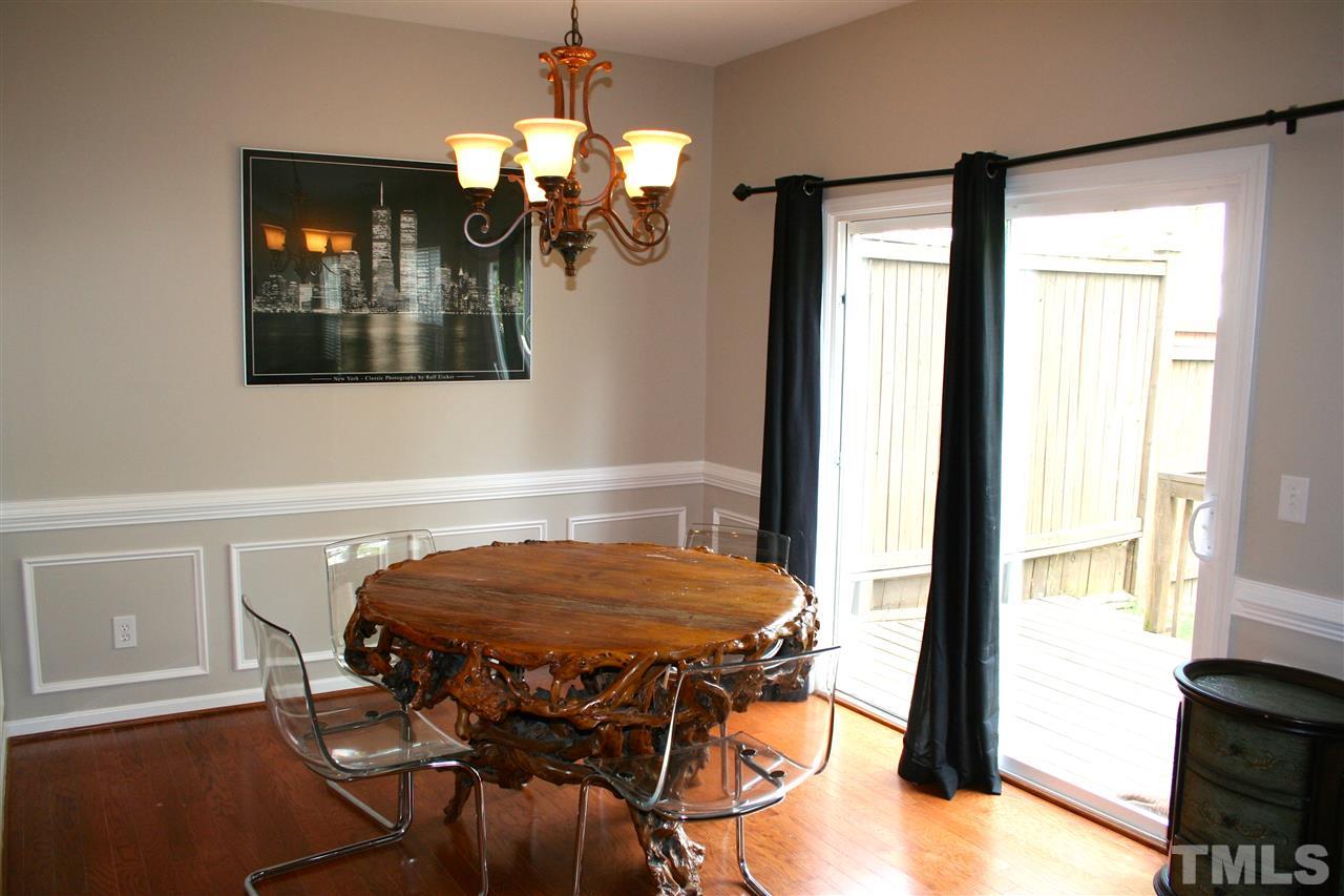 7727 Tanby Court Raleigh, NC 27613 - Photo 7 of 25 a view of a dining room with furniture and chandelier
