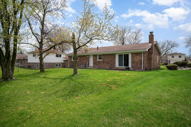 a view of house that has a yard