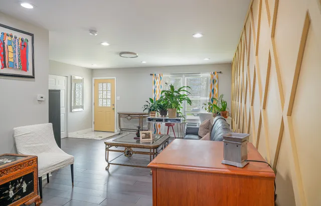 a living room with furniture and a potted plant