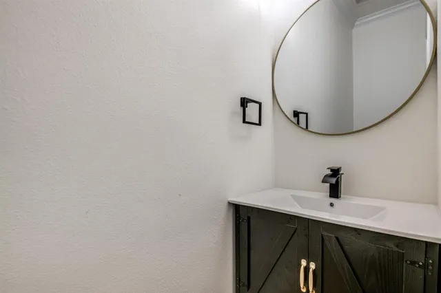a bathroom with a sink and mirror