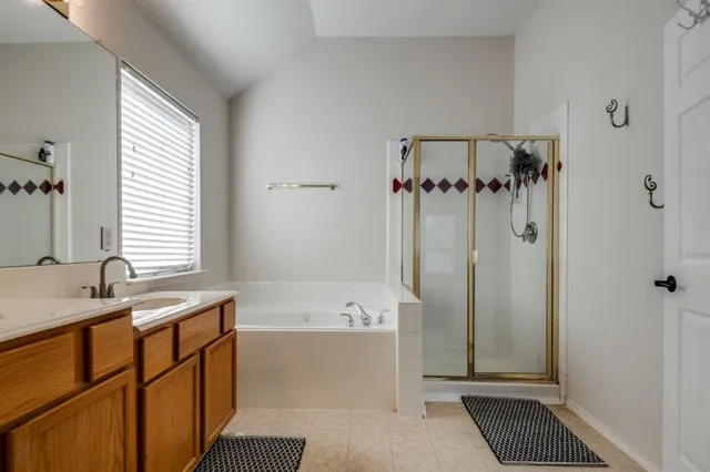 a bathroom with a tub sink and mirror