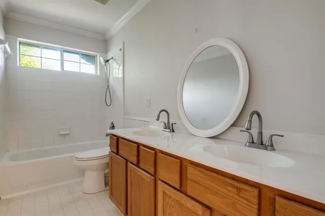 a bathroom with a granite countertop toilet a sink and a mirror