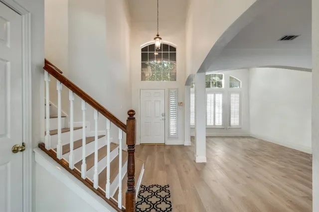 a view of an entryway with wooden floor