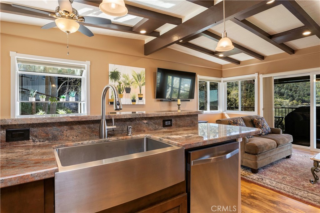 3103 Manzanita Road Kelseyville, CA 95451 - Photo 20 of 62 a dining hall with stainless steel appliances granite countertop a stove a sink dishwasher a dining table and chairs with wooden floor