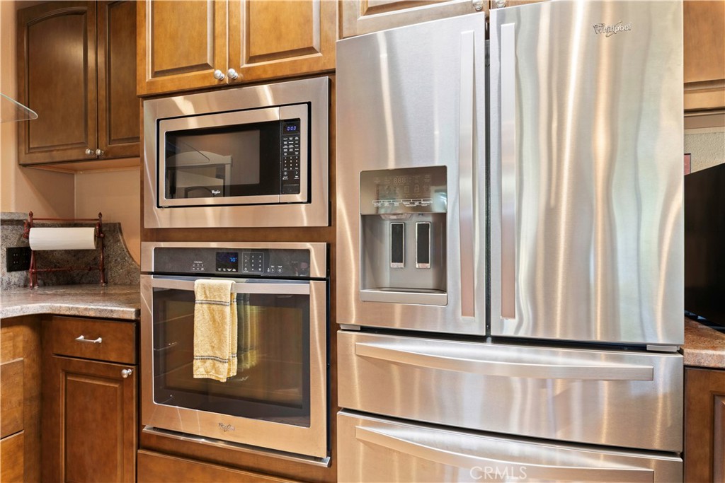 3103 Manzanita Road Kelseyville, CA 95451 - Photo 22 of 62 a kitchen with granite countertop white cabinets and stainless steel appliances