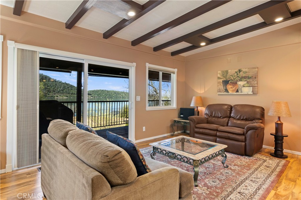 3103 Manzanita Road Kelseyville, CA 95451 - Photo 5 of 62 a living room with furniture a flat screen tv and a floor to ceiling window