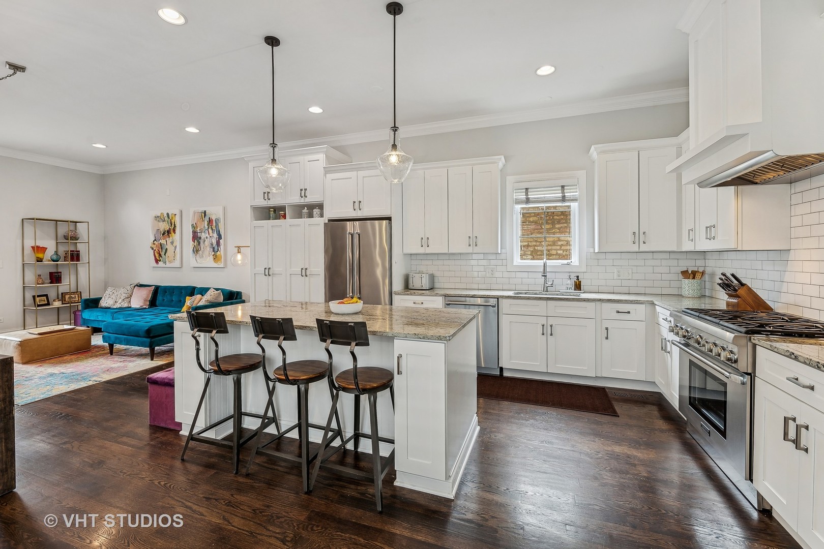 3409 North Ridgeway Avenue Chicago, IL 60618 - Photo 11 of 37 a kitchen with stainless steel appliances kitchen island granite countertop a stove a sink dishwasher a refrigerator white cabinets with wooden floor